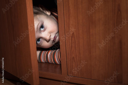 Scared child hiding