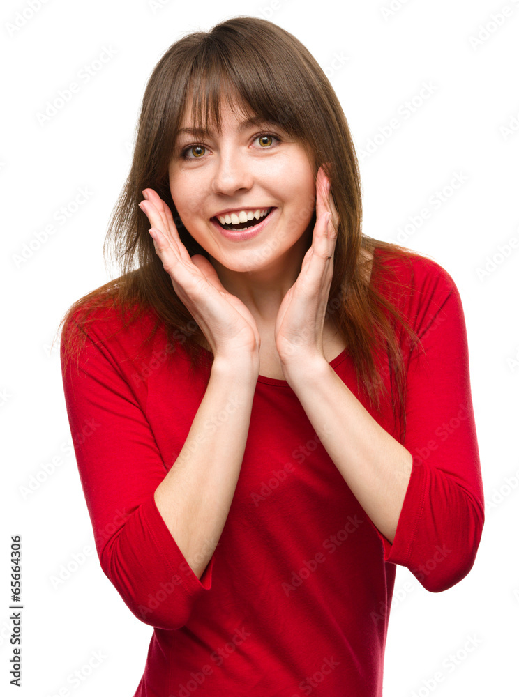 Woman is holding her face in astonishment Woman is holding her face in astonishment
