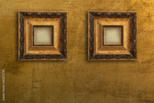 two vintage gold picture frames on the wall gold