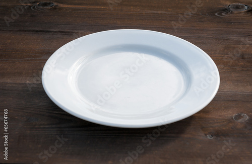 White plate on wood desk