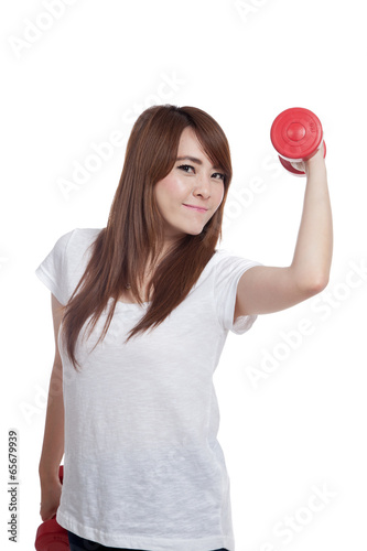 Happy Asian girl lift a dumbbell with confidence