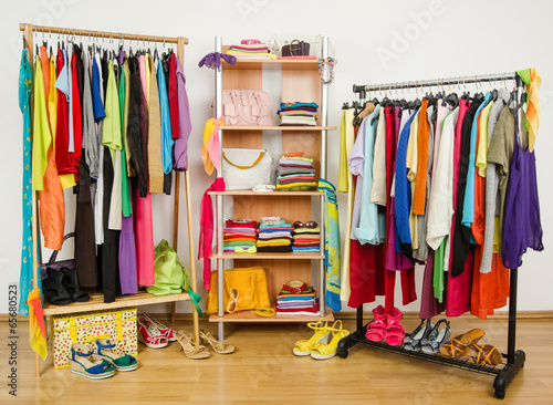Wardrobe with summer clothes and accessories nicely arranged.