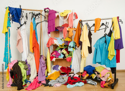 Untidy cluttered woman wardrobe with clothes and accessories.