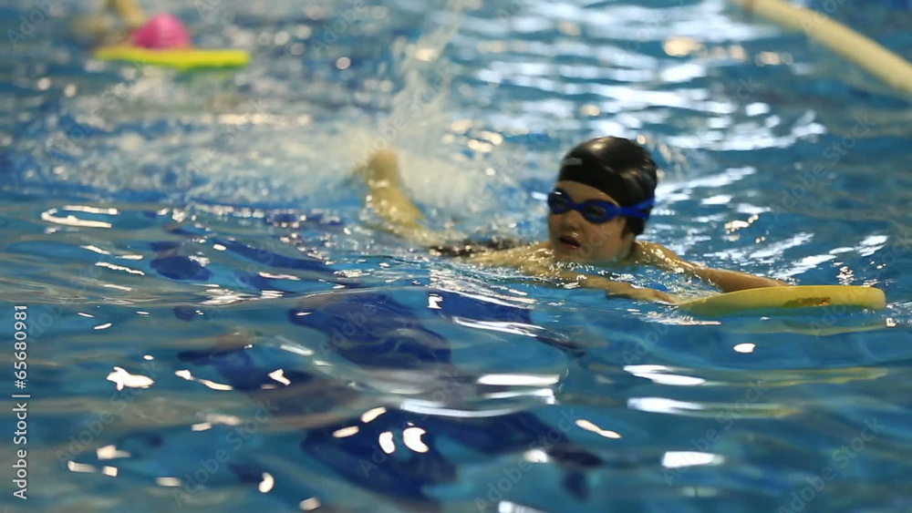 little child training in swim pool