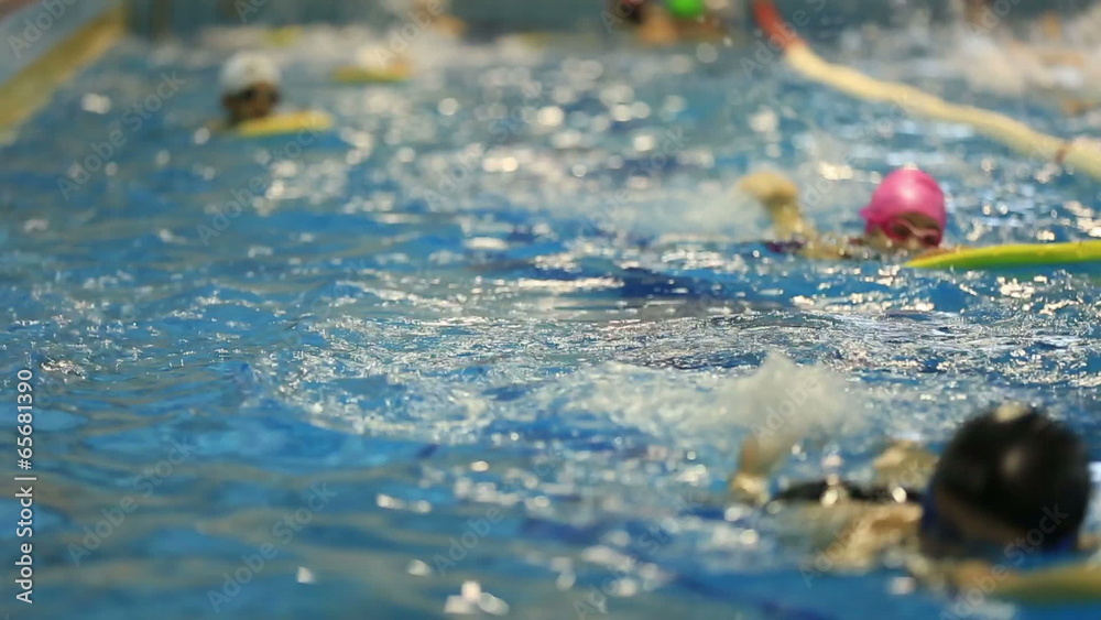 little child training in swim pool
