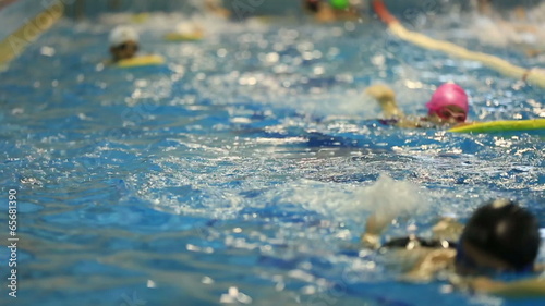 little child training in swim pool
