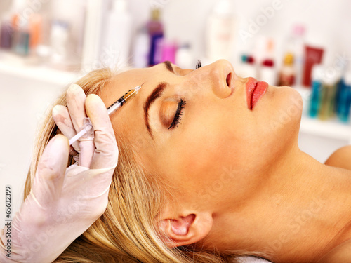 Woman giving botox injections.