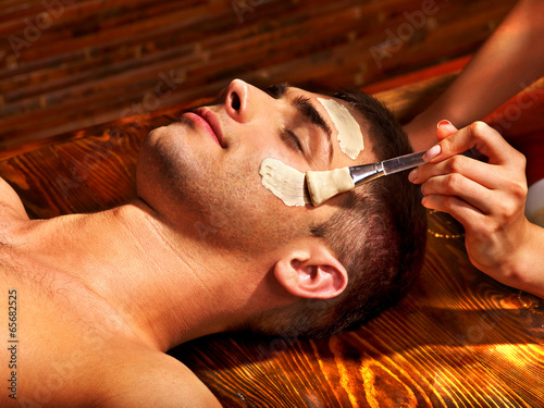 Clay facial mask in beauty spa. #65682525
