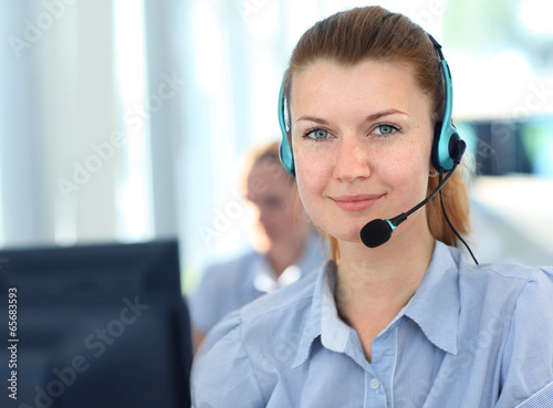 Female customer support operator with headset and smiling