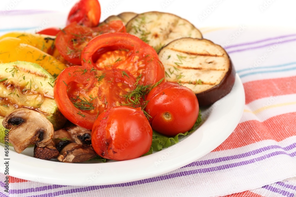 Delicious grilled vegetables on plate on table close-up Delicious grilled vegetables on plate on table close-up