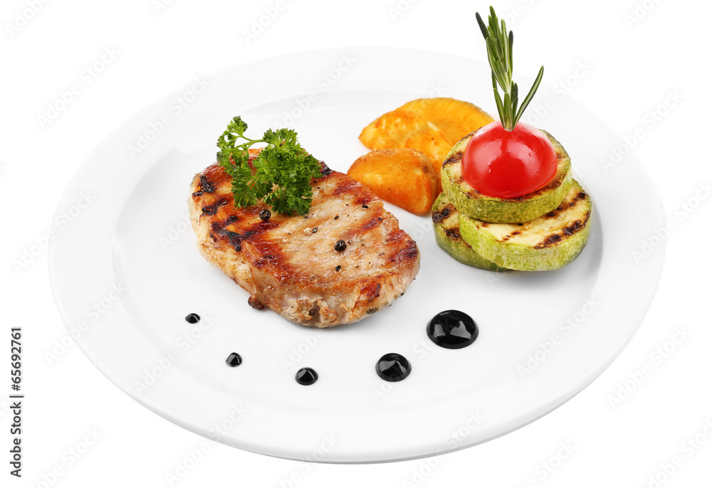 Grilled steak and grilled vegetables on plate, isolated on Grilled steak and grilled vegetables on plate, isolated on