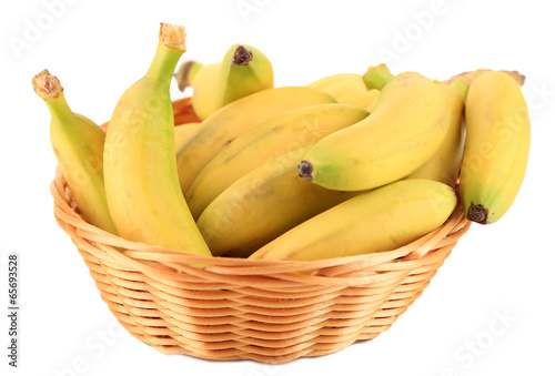 Bunch of mini bananas in wicker basket isolated on white