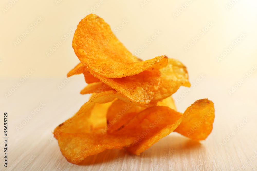 Heap of homemade potato chips on light background Heap of homemade potato chips on light background