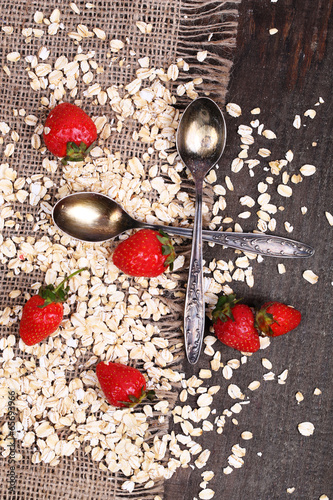 Strawberries with oatmeal and vintage spoons,