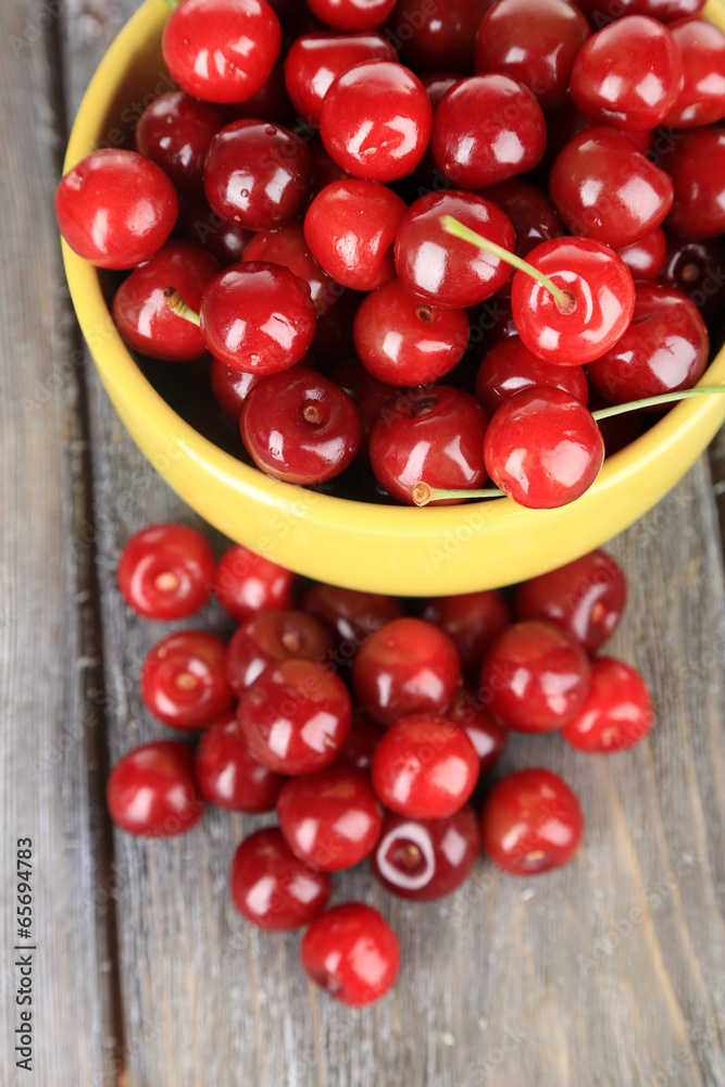 Sweet cherries in mug on wooden background Sweet cherries in mug on wooden background