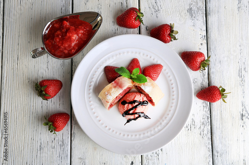 Tasty homemade strudel with ice-cream, fresh strawberry and