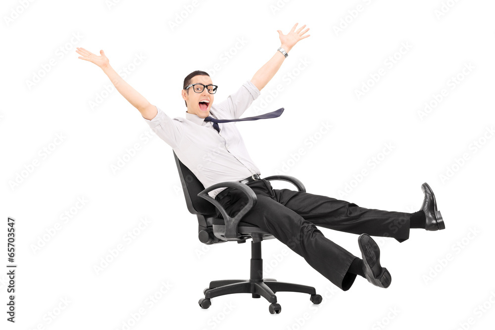 Man riding in an office chair and gesturing joy