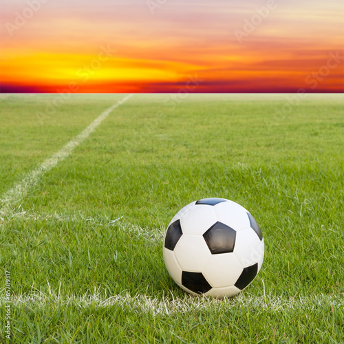 soccer ball on soccer field against sunset sky © Satit _Srihin