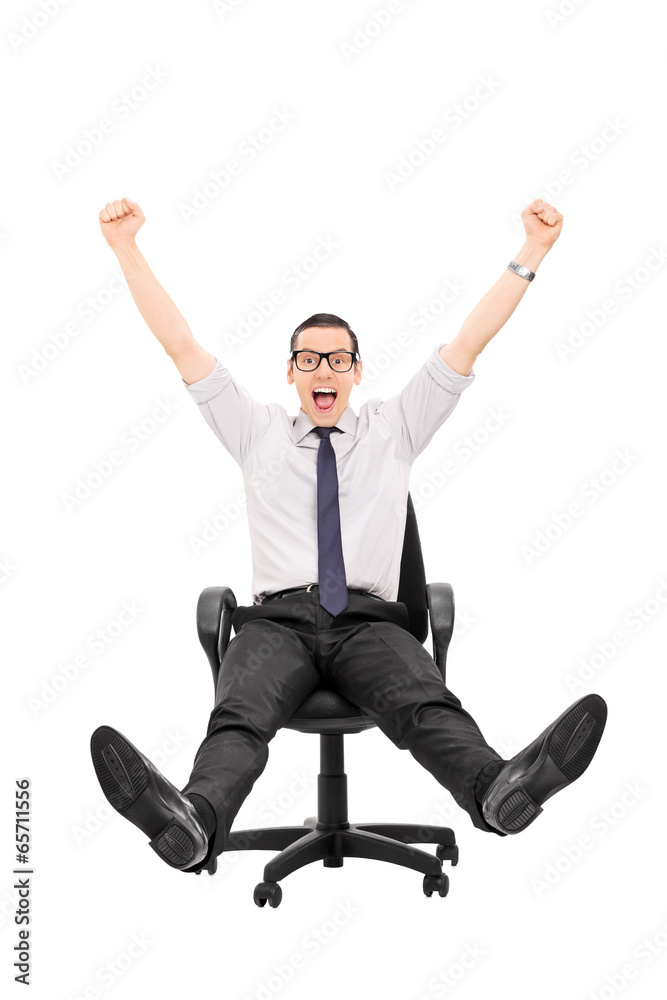 Overjoyed man riding in an office chair