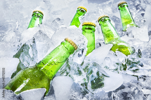 Cold beer bottles on ice