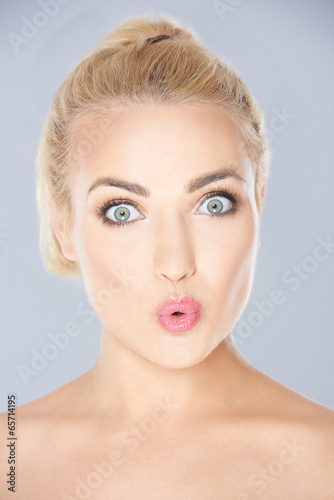 Beautiful young woman looking surprised