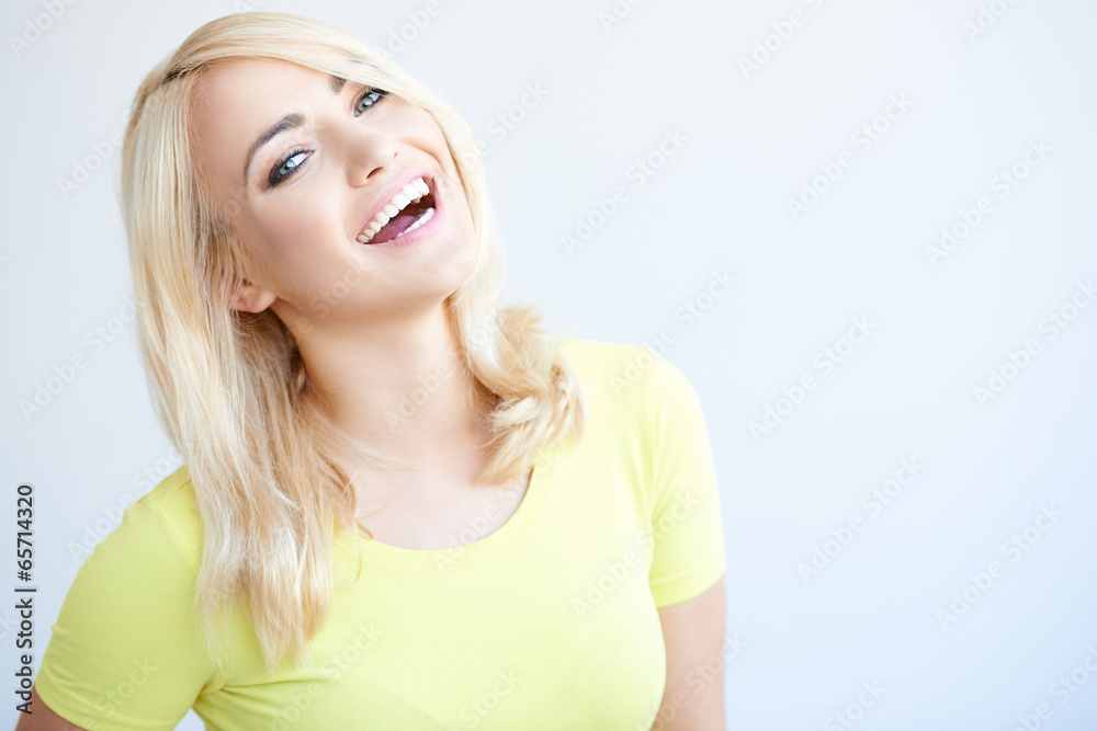 Fototapeta premium Vivacious young woman laughing at the camera