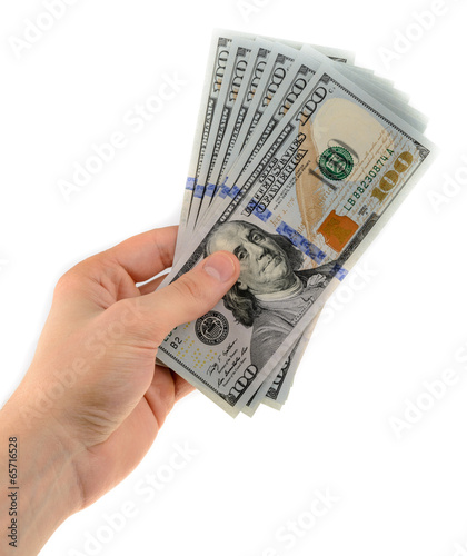 Man's hand holds a fan of dollars isolated on white background photo