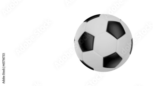 Soccer ball flies at the camera then stops but keeps rotating. photo