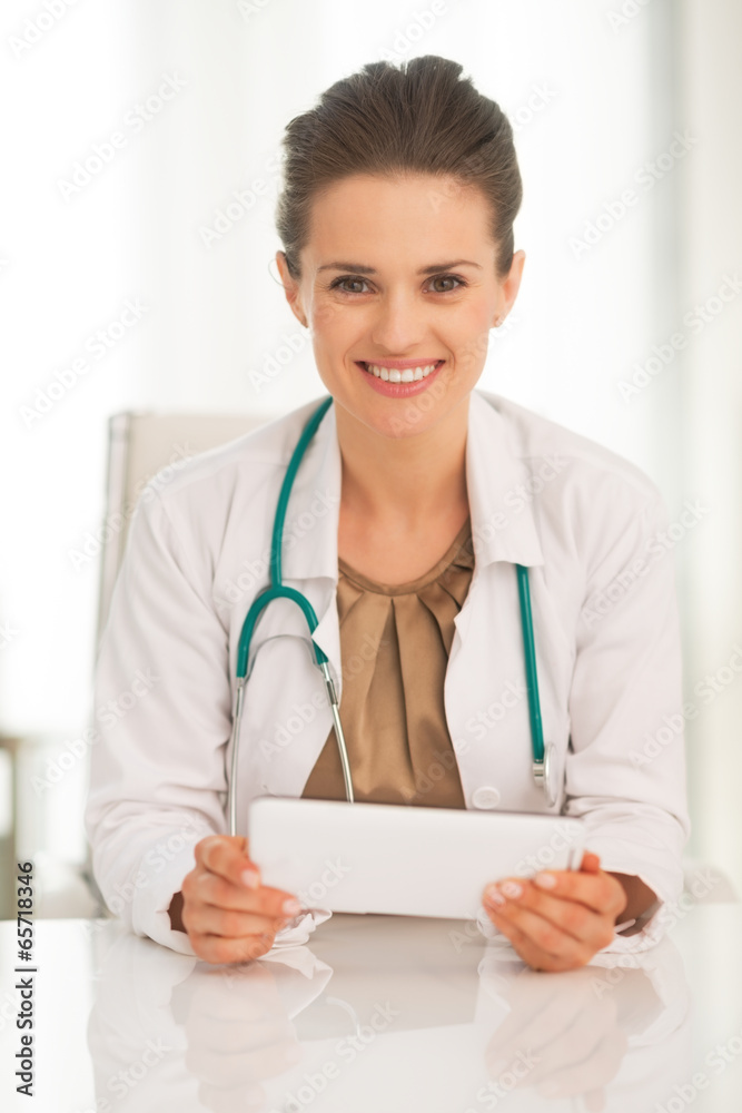 Portrait of happy medical doctor woman using tablet pc Portrait of happy medical doctor woman using tablet pc