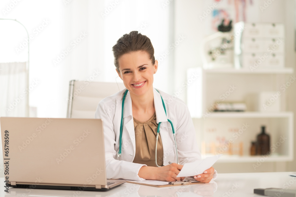 Happy medical doctor woman working in office Happy medical doctor woman working in office
