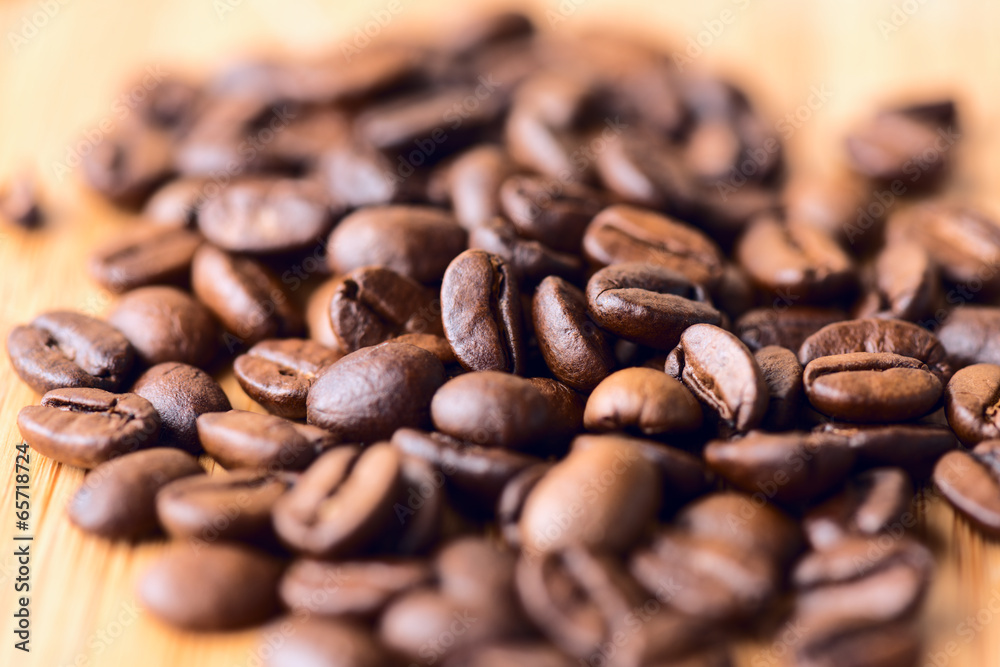 Cofee beans macro on wooden table Cofee beans macro on wooden table