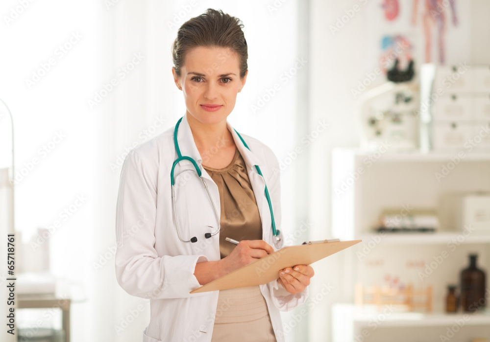 Portrait of medical doctor woman writing in clipboard Portrait of medical doctor woman writing in clipboard