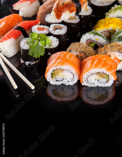 Delicious sushi pieces on black background #65718972
