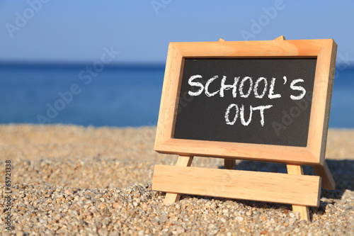 Photography Blackboard with School's out text on the beach