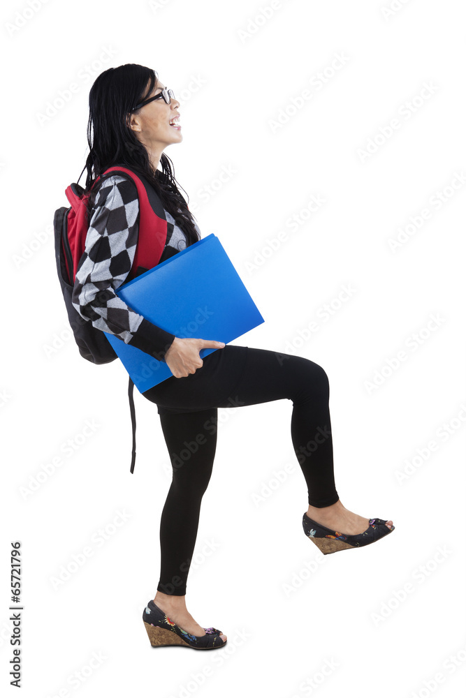 Fototapeta premium Student in pose stepping upward