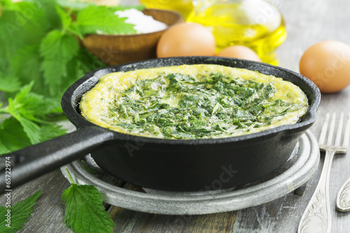 Omelet with nettles in the pan