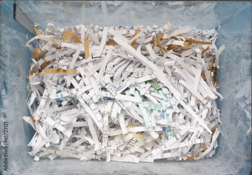 Plastic container of shredded confidential documents photo