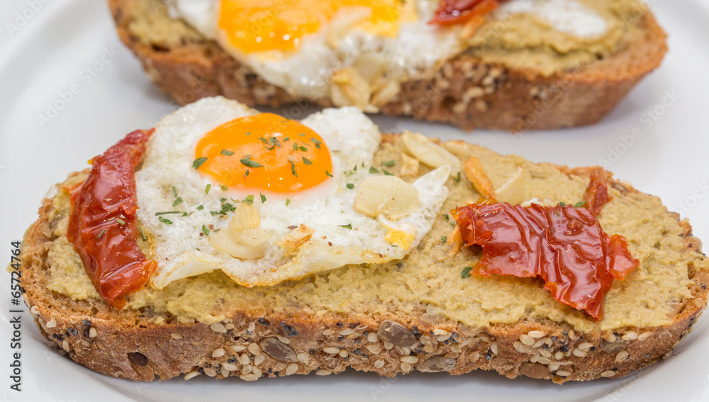 Closeup of Spanish Tapa with Fried egg and dry tomato