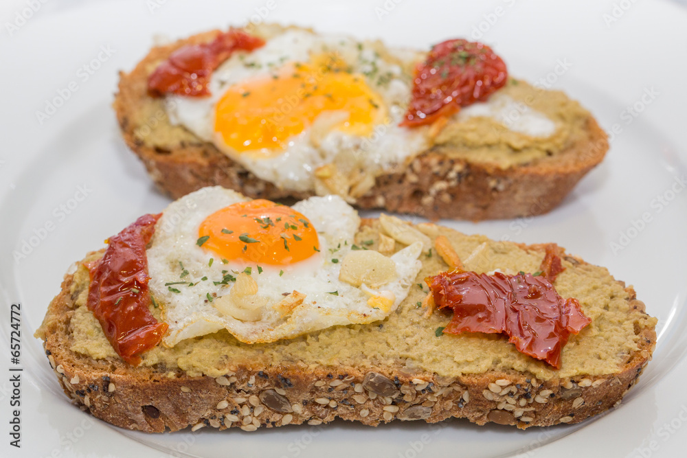 Closeup of Spanish Tapa with Fried egg and dry tomato