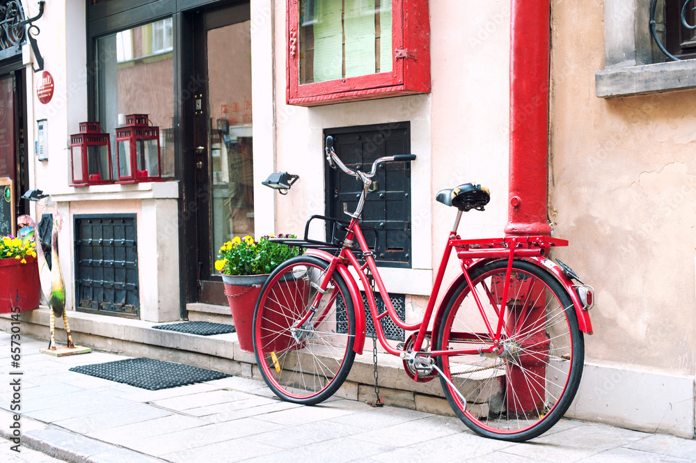Red rustic retro bicycle. Outdoors.
