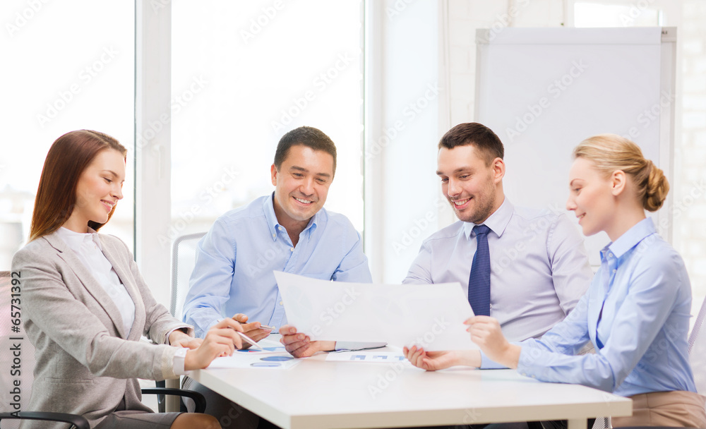 Fototapeta premium smiling business team having discussion in office