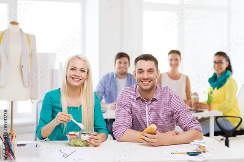 smiling fashion designers having lunch at office