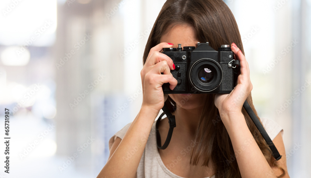Female photographer using a camera