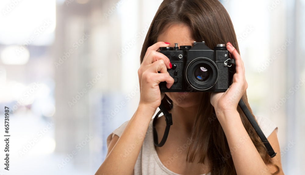 Female photographer using a camera Female photographer using a camera