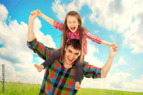 Joyful father with daughter on shoulders