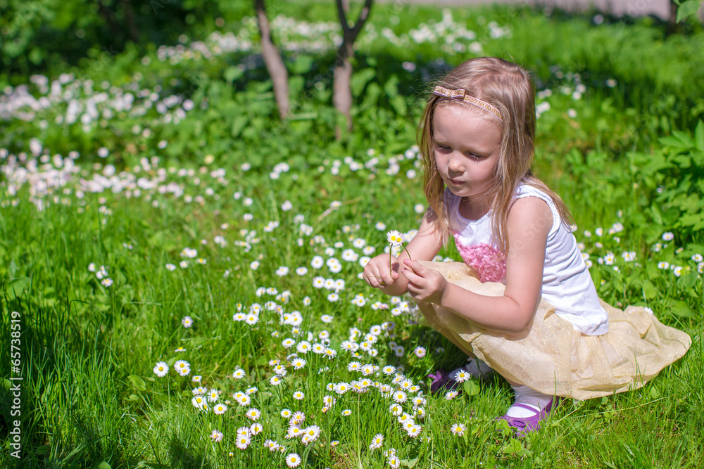 Little girl picking flowers in green glade Little girl picking flowers in green glade