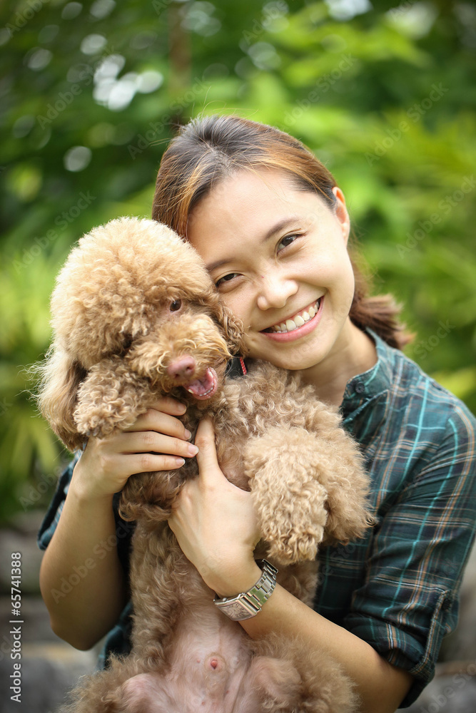 Asian girl play with brown color poodle Asian girl play with brown color poodle