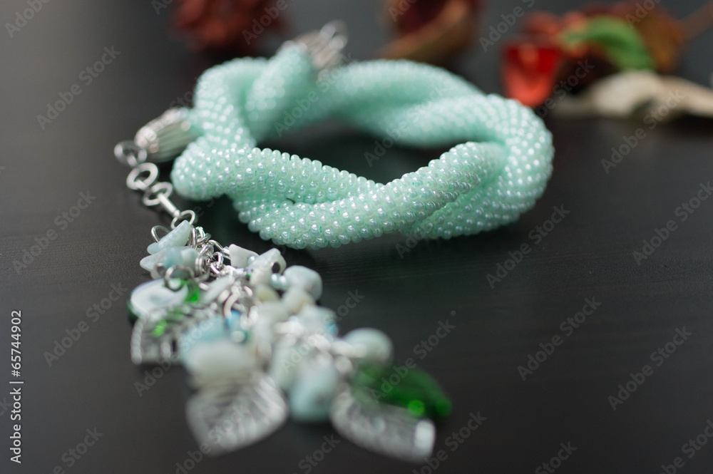 Necklace of mint color on a wooden background Necklace of mint color on a wooden background