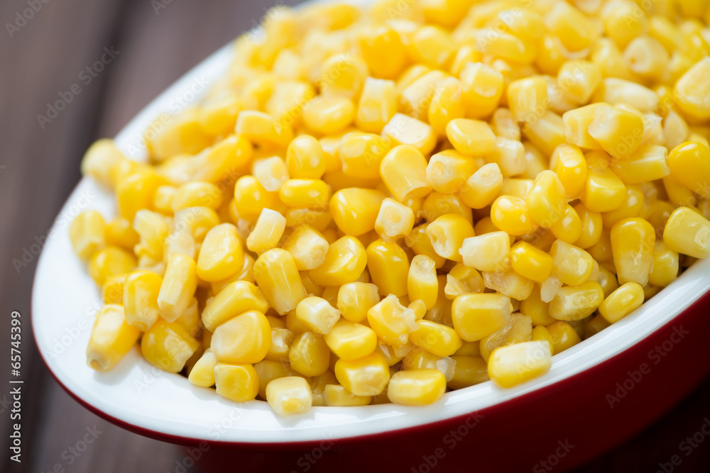 Glass bowl with sweet corn kernels, close-up, horizontal shot Glass bowl with sweet corn kernels, close-up, horizontal shot