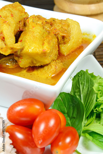 Spicy Pork Rib Curry with Tumeric Root Served with Fresh Vegetable, Tomatoes and Streamed Rice. photo